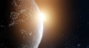 planeta terra e o sol ao fundo e a reflexão sobre o que é transição planetária
